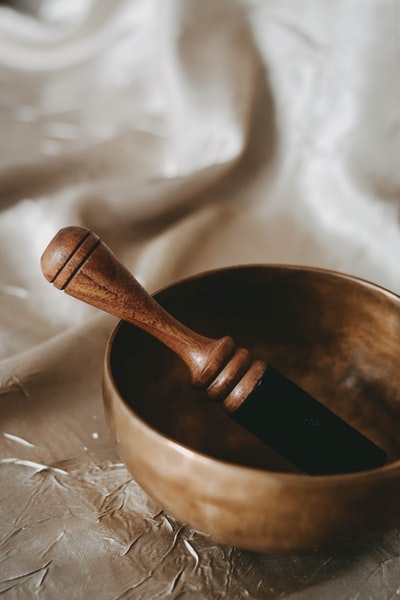 Brown wooden bowl on the brown wooden spoon
